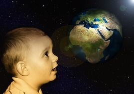 child looking at the globe on a black background