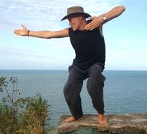 man on a stone in a pose of success