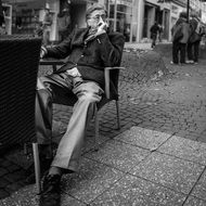 mature man sits on terrace, germany, frankfurt
