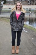 attractive young caucasian girl standing on road looking straight