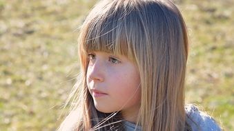 portrait of a girl with long hair in a meadow