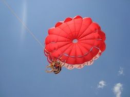 children on a red parachute in flight