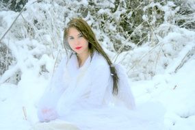 girl in a white dress on a background of snowy nature