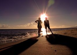 silhouettes of people on the background of the sun
