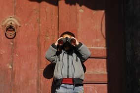 child looking through binoculars