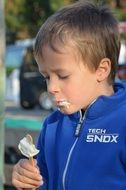 child eating white ice cream