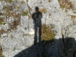 Shadow of a man on a stone wall