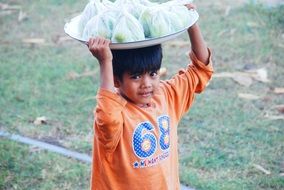 child with tray on head, burma