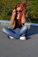 picture of the girl is sitting on a road