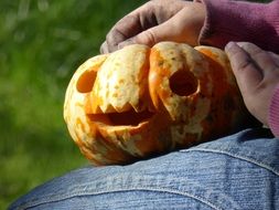 pumpkin with a face in his hands