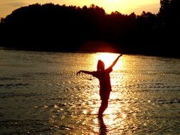 girl in the water sunset