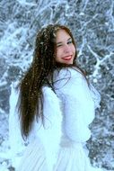 girl in a white coat with wings in winter