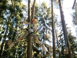 girl in a rope park in nature