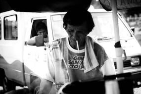 black and white photo of a man with a cigarette