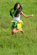 girl jumping on green grass