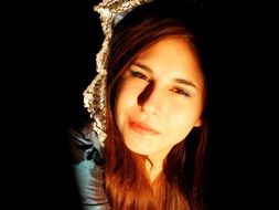 Face of a beautiful brown-haired woman in bright light