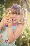 funny girl blond with banana in hands