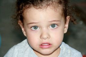 blue-eyed toddler with curly hair