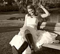 girl in a wedding dress on a bench