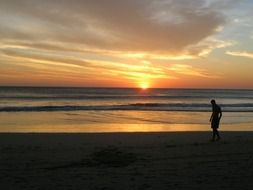 man on the beach during sunset