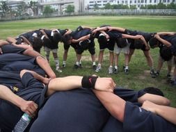 rugby teammates stand in a circle