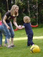 mother with a child near a swing in the park