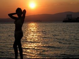 figure of a girl against the backdrop of the sea sunset