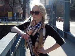 photo of a girl in a plaid scarf on a bridge in Bara, Sweden