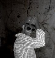 man with glasses and hat posing
