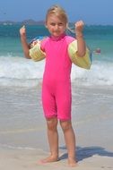 sporty girl wearing pink near the sea