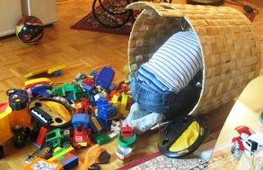 baby in a basket with toys