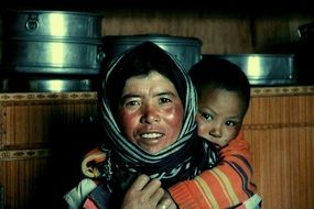 a mother with a child behind Tibet