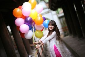young pretty asian girl with balloons