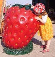 child is drinking from strawberry fountain