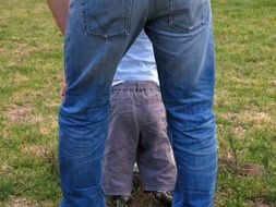 father teaches a child to walk