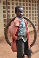 african boy plays with bike tire