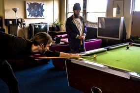 Men are playing snooker