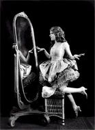 black and white photo of Mary Pickford near the mirror