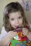 portrait of girl is eating a cupcake