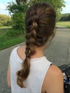 girl on a bicycle with a braid