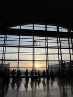 dark silhouettes of people at the airport