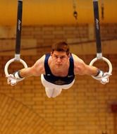 athlete on the sport rings in the gym