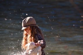 pretty girl long hair in hat water view