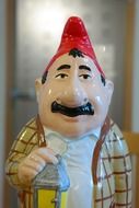 porcelain figurine of dwarf man with lantern