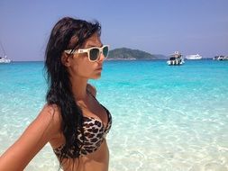 Photo of young girl in bikini on the beach