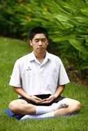 buddhist is meditating on green grass