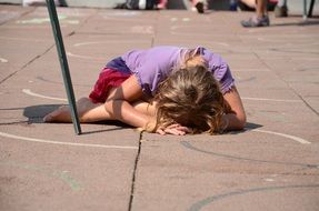 young girl crying on the ground