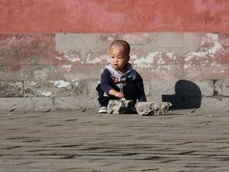 child on the pavement in china