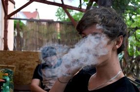 Portrait of young man and weed smoke