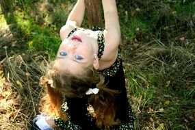 little girl with blue eyes on green grass